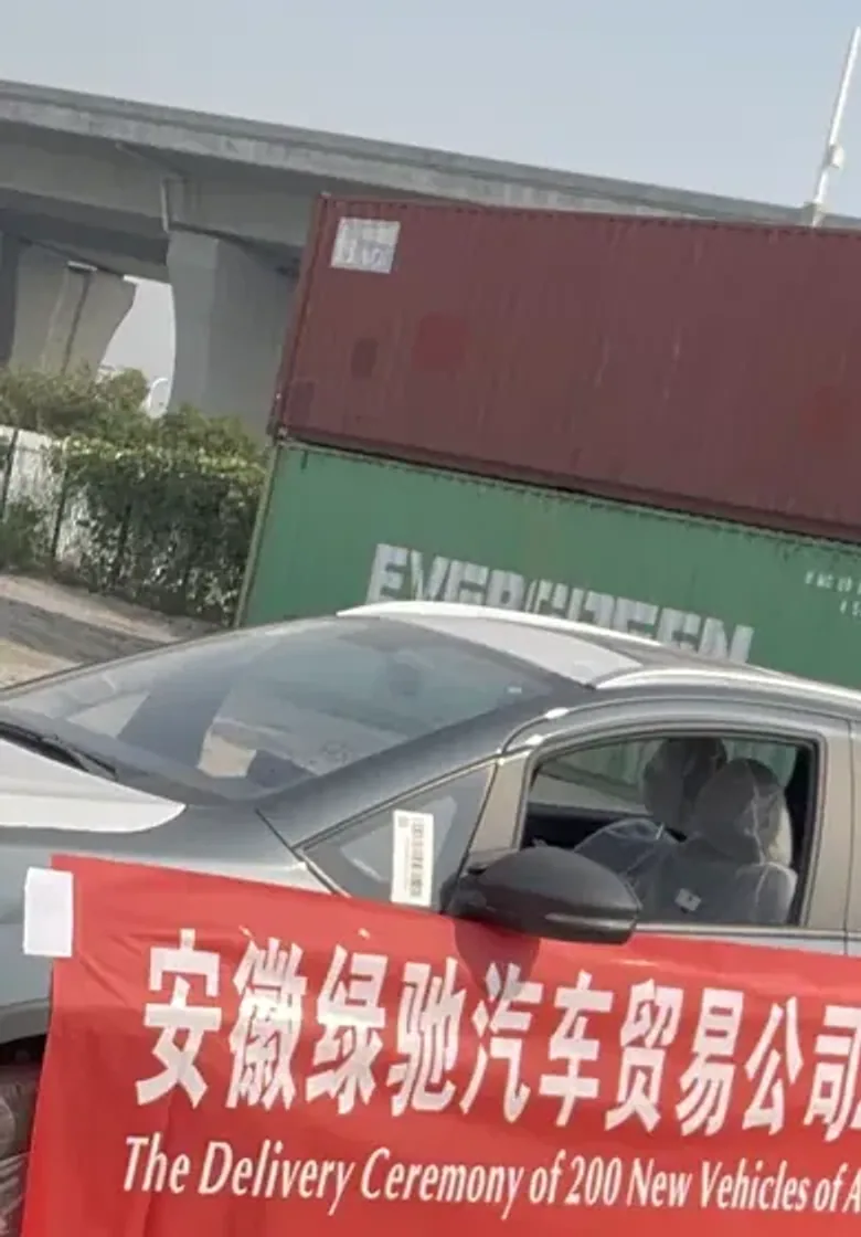 Vehicles, export containers and the Green Gallop 200-vehicle delivery banner